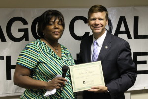 SAGE leader Glenda Sykes presents Sen. Righter with his award in July.