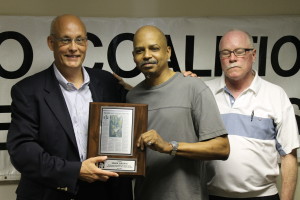 Mark Brown accepting his award from Ewing Manager Michael and CCH Organizing Director Jim Field.