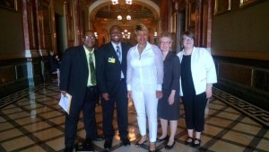 Jonathan Holmes (second from left), with CCH's Charles Austin, advocates with Community Renewal Society and Heartland Alliance, and State Sen. Patricia Van Pelt (middle), sponsor of HB 494.