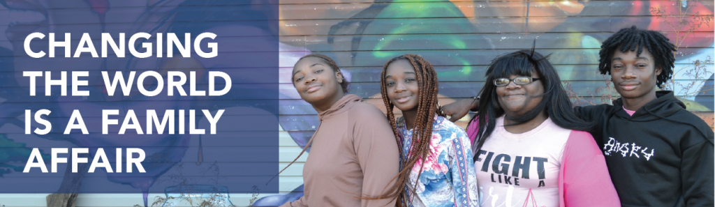 Horizontal banner. White text in blue box reads: "Changing the world is a family affair." Includes photo of a smiling Black family (two teen girls, one adult woman, and one teen boy) posing in front of a colorful mural. 