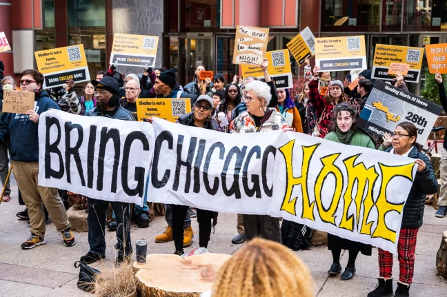 BCH supporters hold a banner reading "Bring Chicago Home" after the City Council put the measure on the 2024 ballot. (Block Club Chicago)