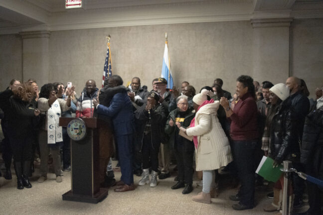 Mayor Brandon Johnson and other BCH supporters celebrate together inside Chicago City Hall.