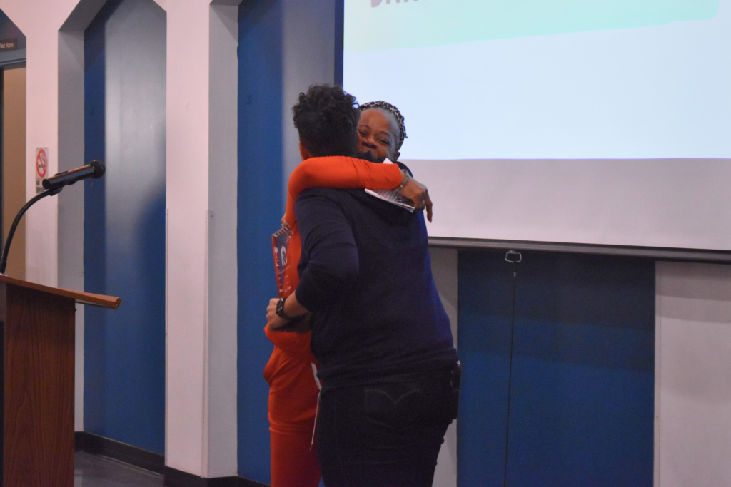 Carla Johnson, a CCH Board Member and grassroots leader, hugs Ald. Hadden while presenting her award.