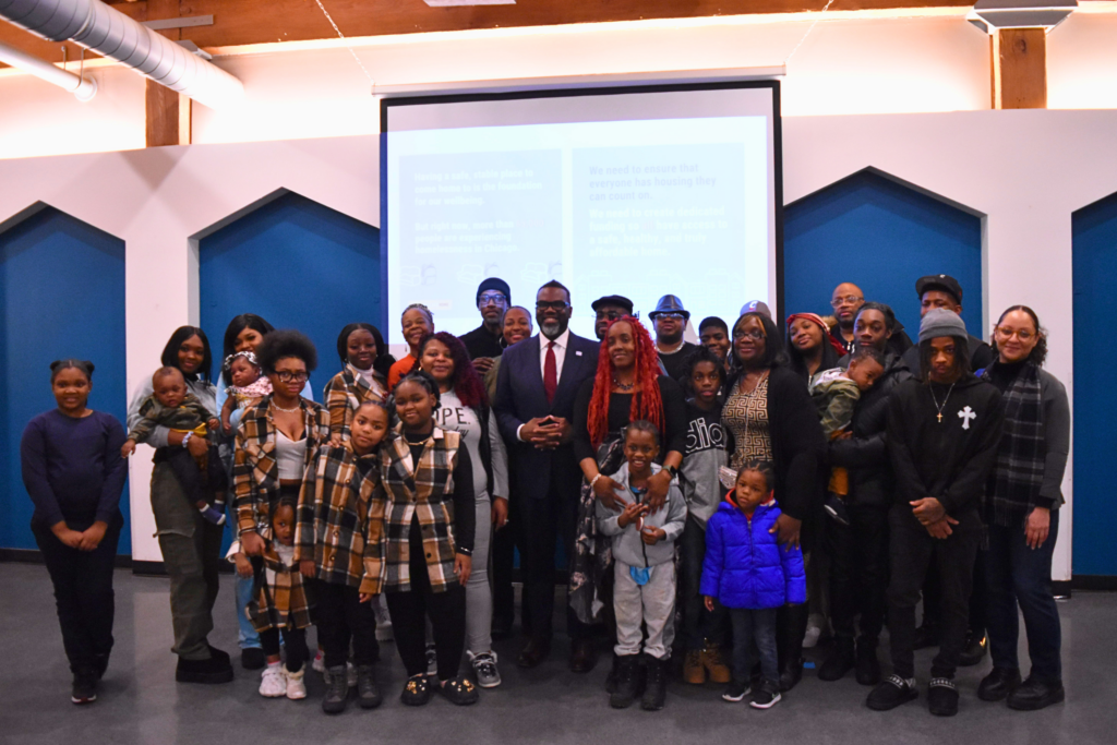 CCH grassroots leaders and their families pose with Mayor Brandon Johnson.